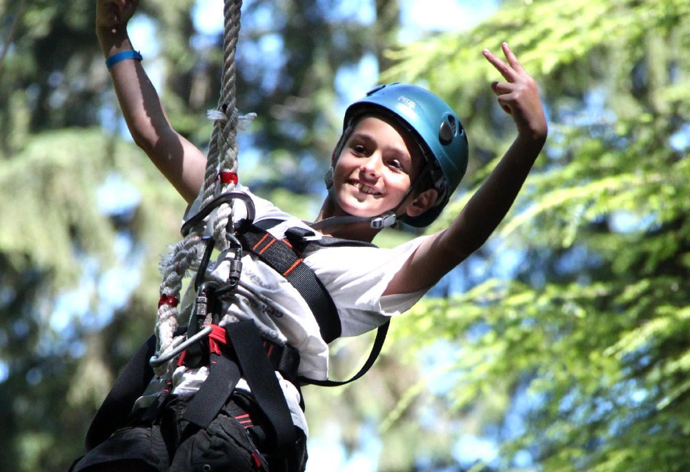 child on zipline - happy kid